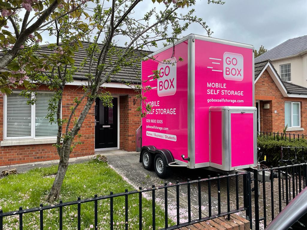 Mobile self-storage unit, a practical storage solution, parked in front of a residential home.