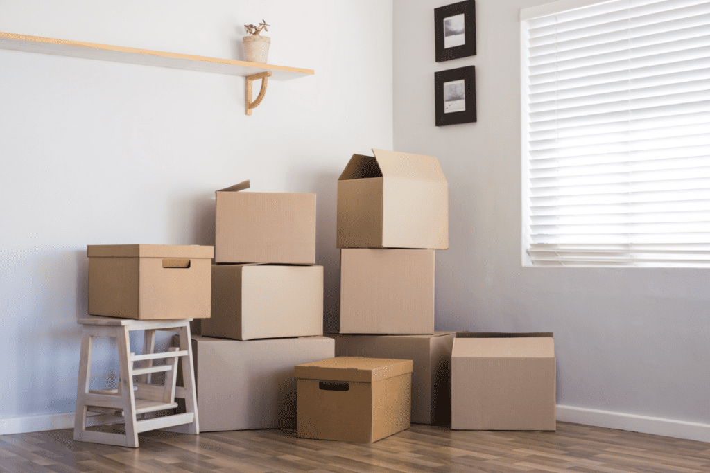 Stacked moving boxes in a room, suggesting relocation or storage.