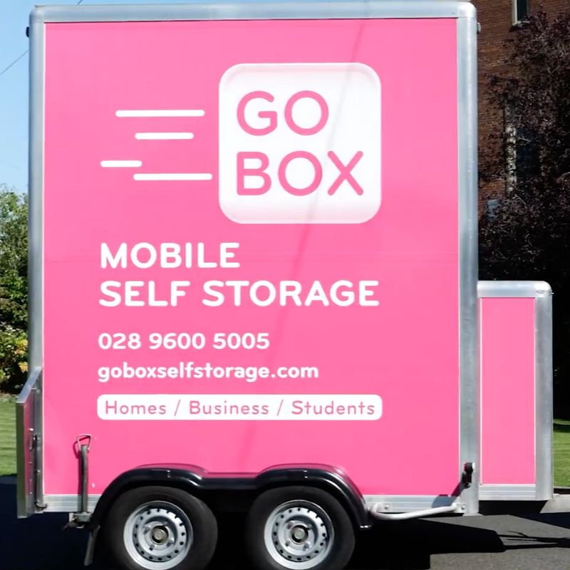 A pink mobile self-storage units truck with the branding 'go box' targeted at entrepreneurs and start-ups on the side.