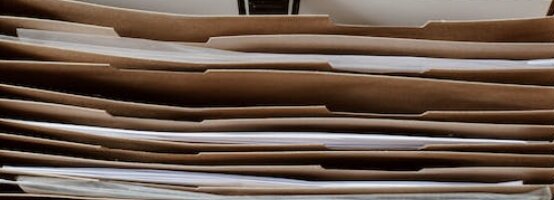 Stack of paper-filled folders and documents.