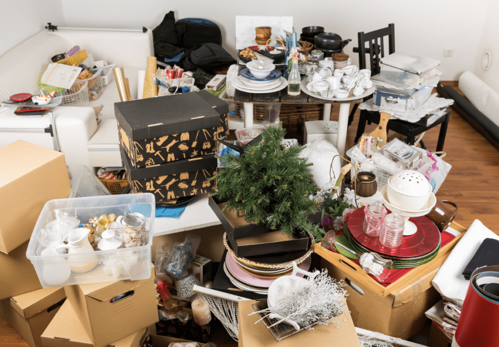 Cluttered room filled with boxes, household items, and decorations.
